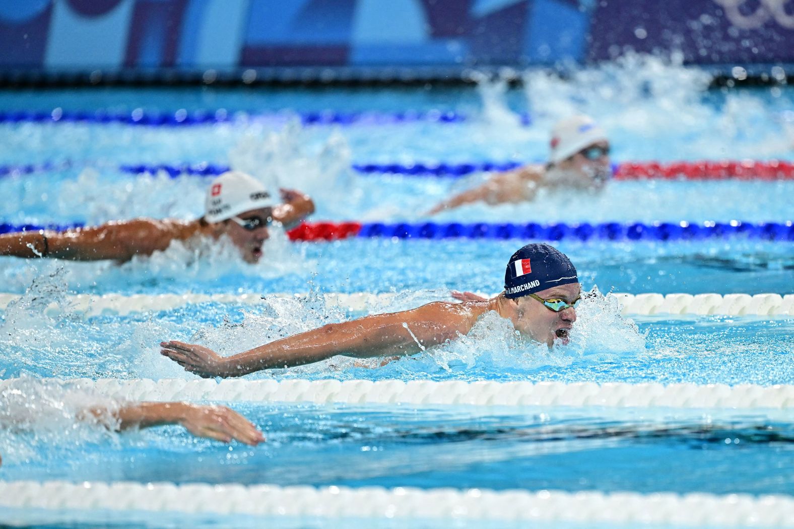 France's Léon Marchand leads the 200-meter butterfly final on July 31. <a >Marchand won the event</a> and then came back to the pool later in the night <a >to win gold in the 200-meter breaststroke</a>. He set Olympic records in both.