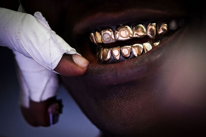 American shot putter Raven Saunders wears gold Olympic-themed grills on August 8. <a >Saunders also donned a black face mask and colorful visor sunglasses</a> while competing. Saunders later said the outfit was all about inspiring people to be themselves.