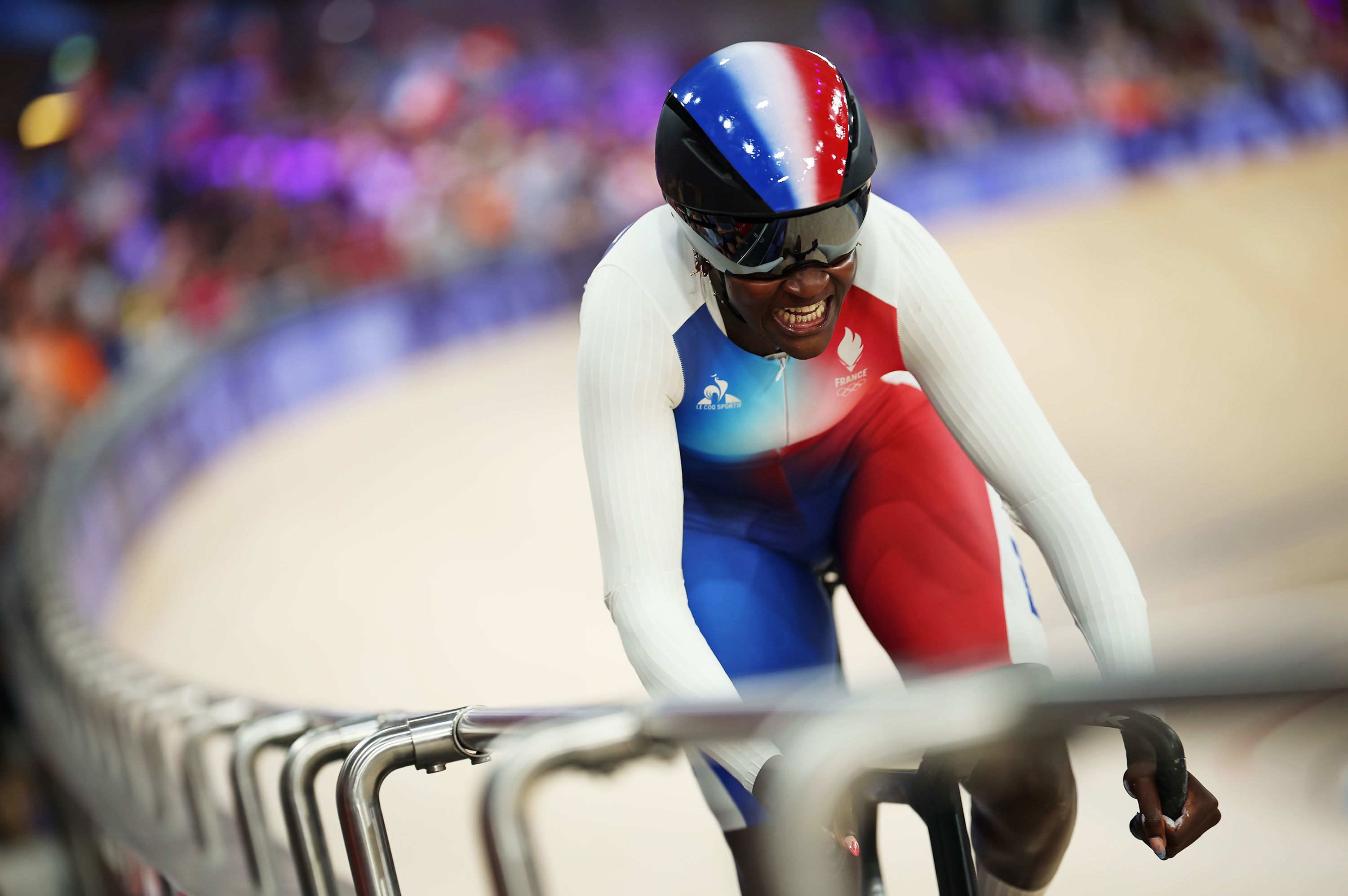 French cyclist Taky Marie-Divine Kouamé races during a sprint qualifier.