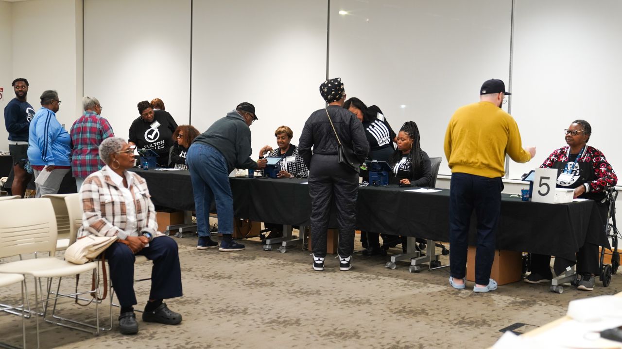 People cast their votes on the first day of early voting in the US Presidential election at Metropolitan library on Tuesday,  October 15, in Atlanta, Georgia.