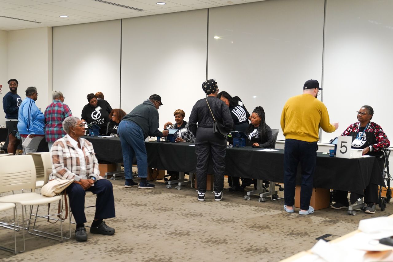 People cast their votes on the first day of early voting in the US Presidential election at Metropolitan library on Tuesday,  October 15, in Atlanta, Georgia.