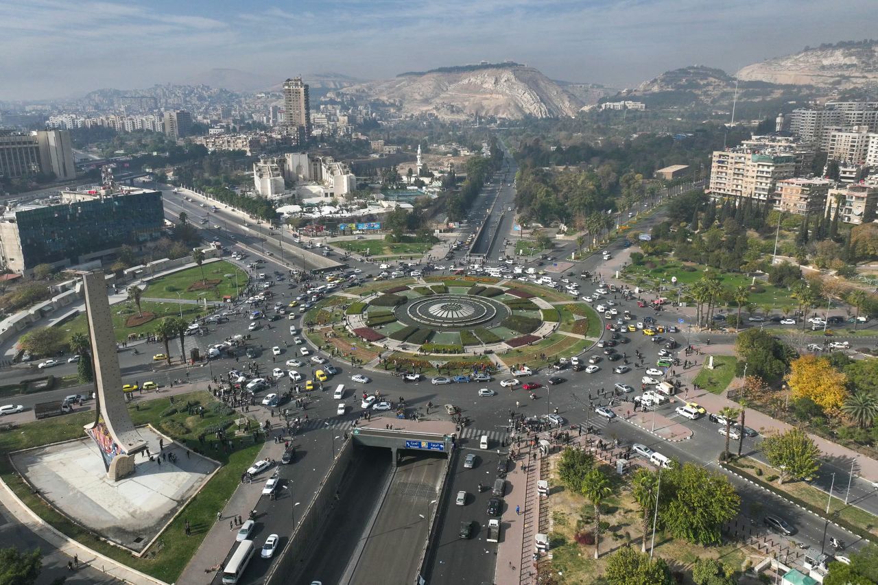 People gather around Umayyad Square in Damascus, Syria, on December 8