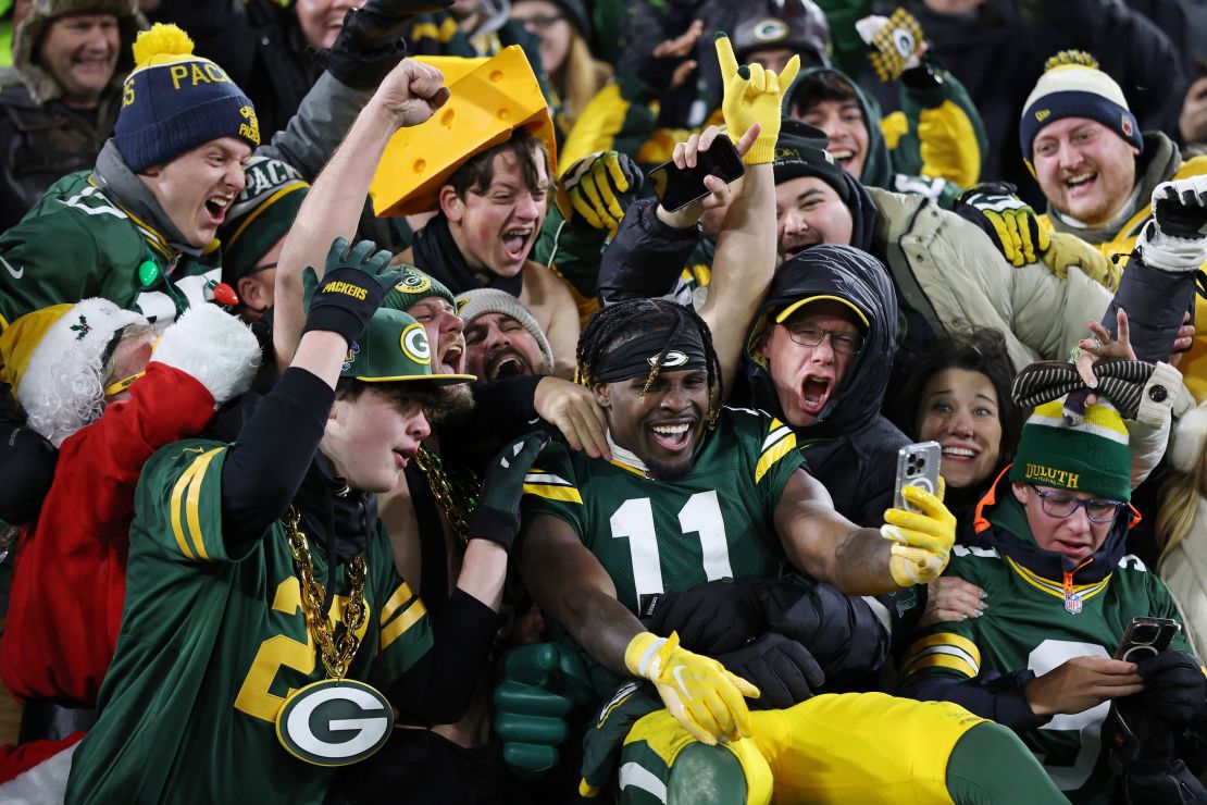 Jayden Reed celebrates with Packers fans after Green Bay defeated the New Orleans Saints at Lambeau Field on December 23.