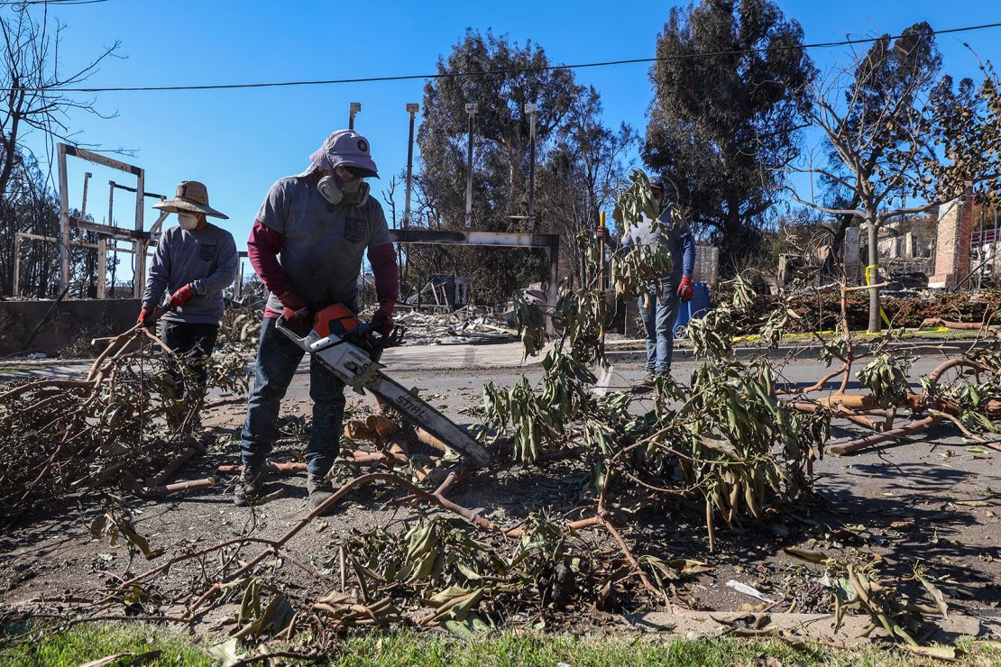 Hart Built Construction employees clean the streets of the Pacific Palisades neighborhood in Los Angeles on January 14.