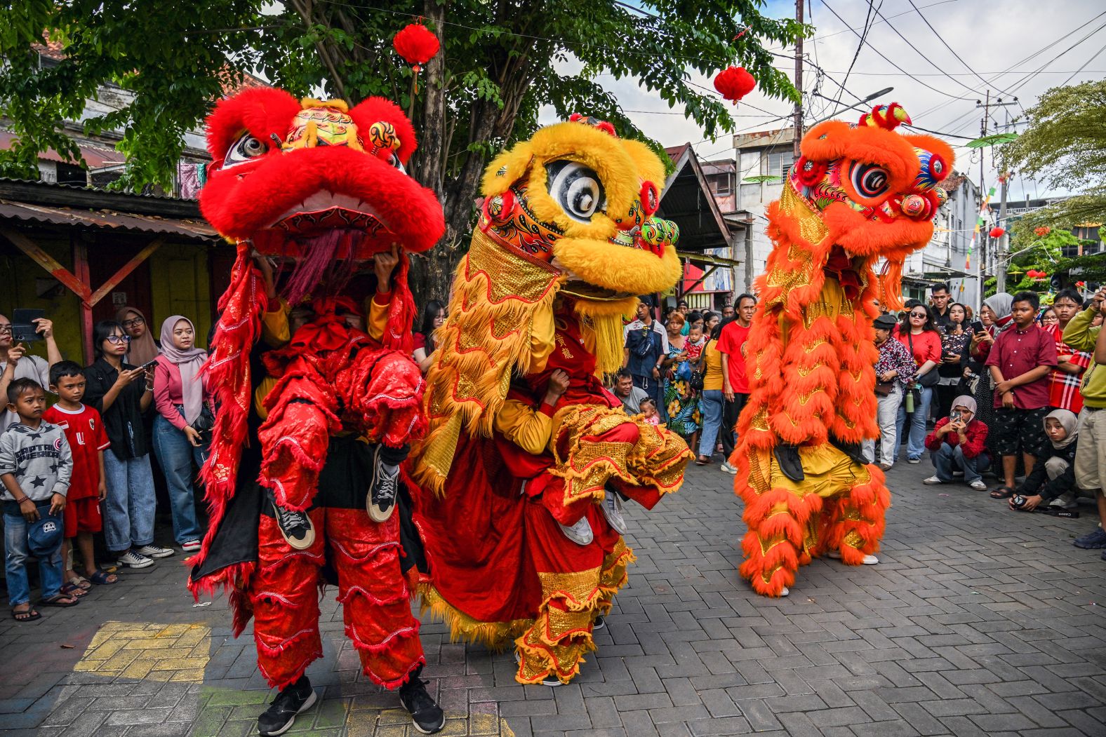 Lion dancers perform for a crowd in Surabaya, Indonesia, as part of <a href="index.php?page=&url=https%3A%2F%2Fwww.cnn.com%2F2025%2F01%2F29%2Fworld%2Fgallery%2Fin-pictures-lunar-new-year-celebrations%2Findex.html">Lunar New Year celebrations</a> on Wednesday, January 29.