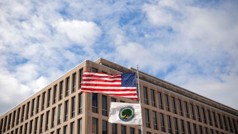 The U.S. flag and Department of Education flags whip in the wind outside the department's headquarters on March 06, 2025 in Washington, DC.
