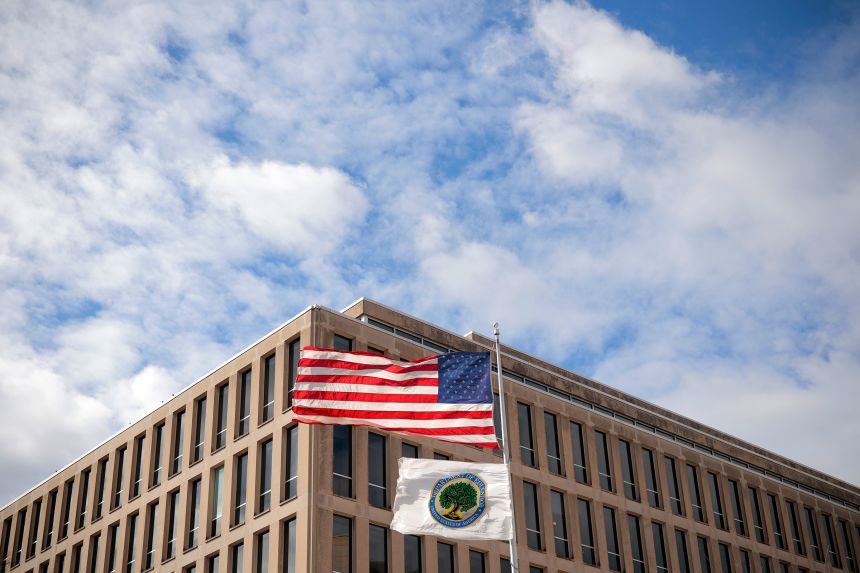 The American flag and Department of Education flags whip in the wind outside the department's headquarters in Washington, DC, on March 6.