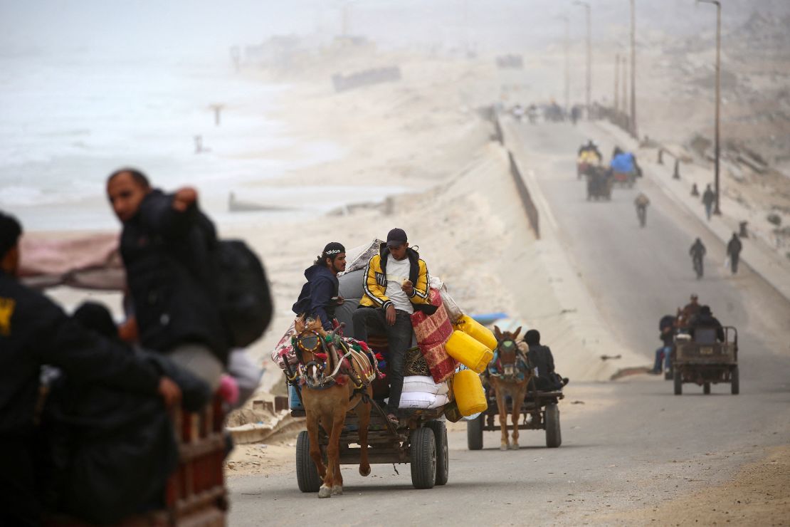 Palestinians flee with their belongings from northern Gaza toward the south via the Salah al-Din road on Thursday.