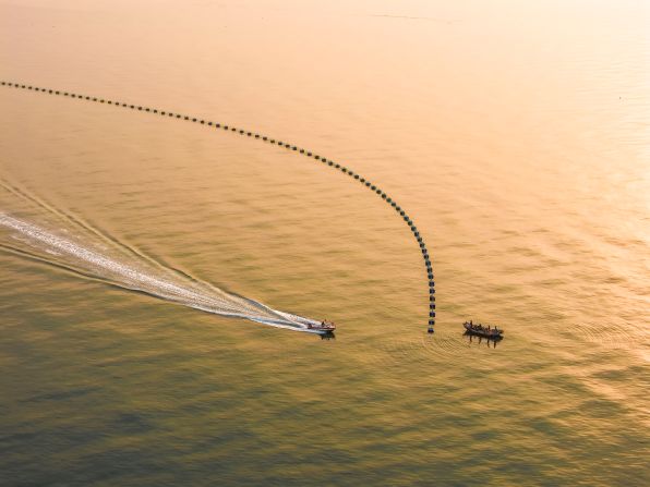 Fishermen harvest oysters in Rizhao, China, on Monday, May 26.
