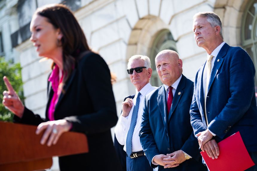 Rep. Glenn Thompson, second from right, watches Agriculture Secretary Brooke Rollins, foreground, speak during a press conference regarding a plan to protect American agriciluture outside the USDA Whitten Building on July 8.