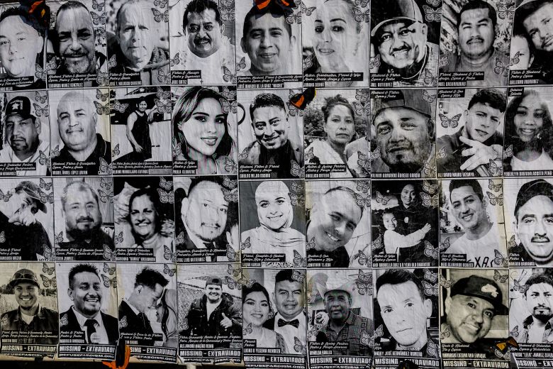 A banner depicting faces of those who have been detained by ICE is displayed during a protest in front of the federal courthouse in Los Angeles on July 17.