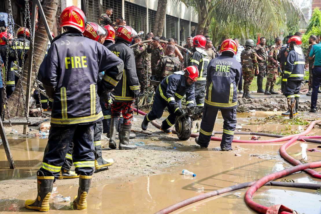 Fire service personnel in Bangladesh clear the remains of an Air Force training jet that crashed into a school, in the capital Dhaka, on July 21. Most of those killed were students.