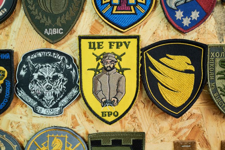 Patches of units operating ground drones are displayed at a classified location in Ukraine on August 8