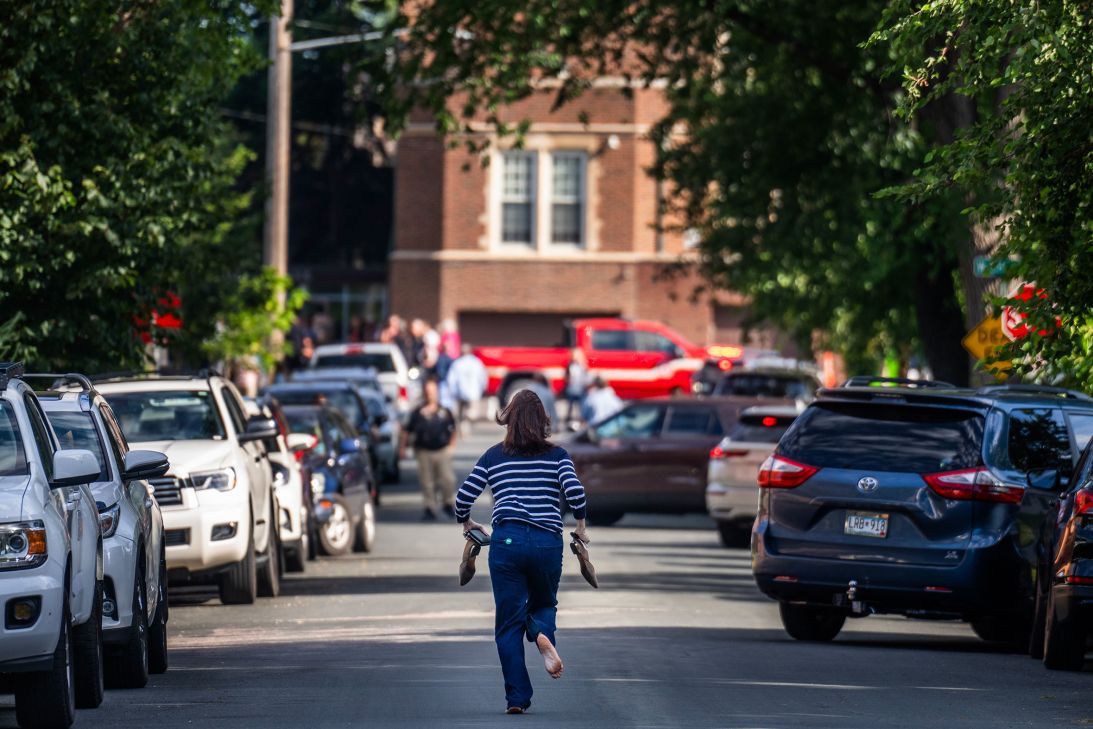 A parent runs toward Annunciation Catholic School during the shooting on Wednesday.