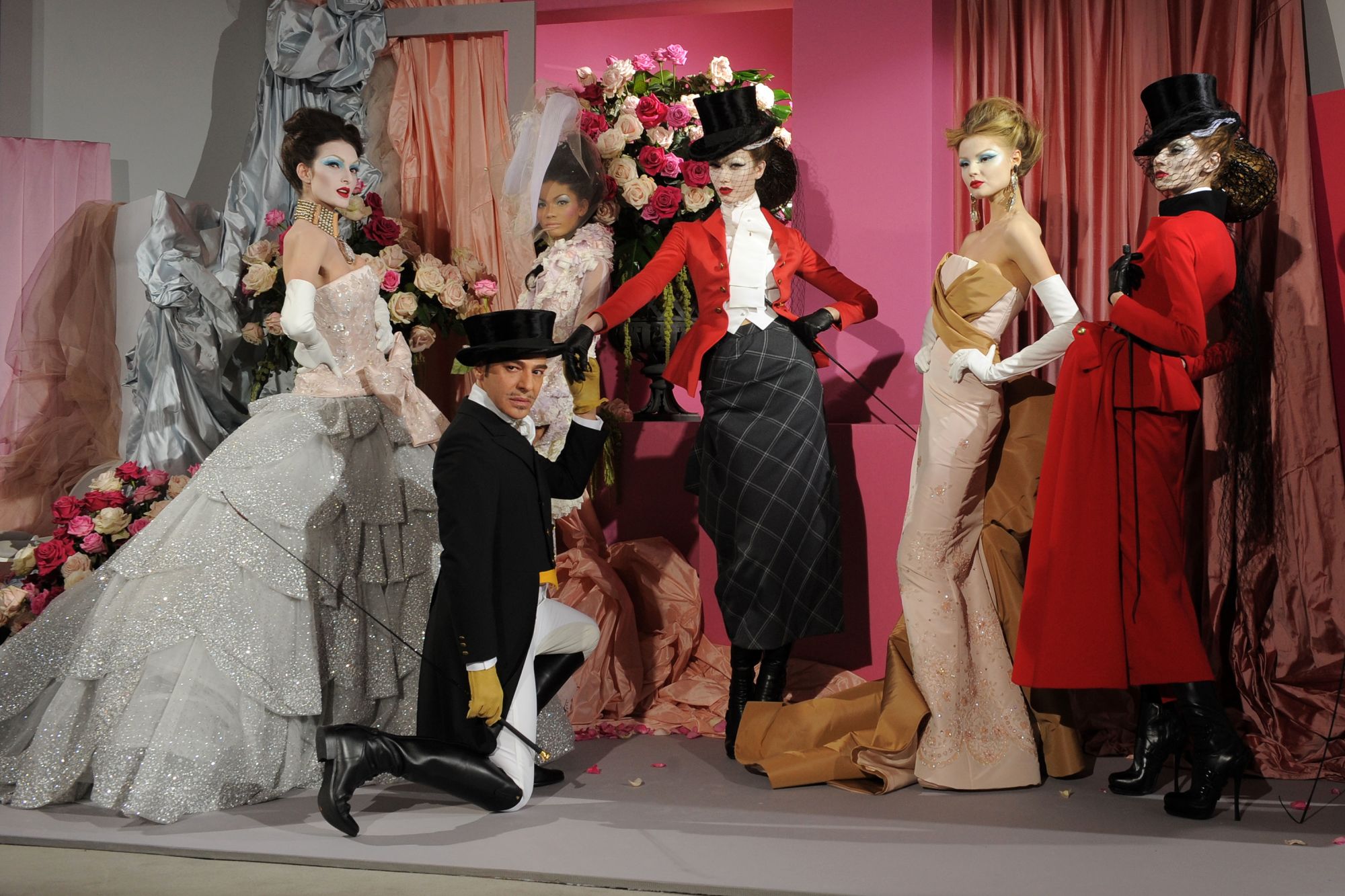 John Galliano poses with models at Dior's Spring-Summer 2010 Haute Couture show in Paris.
