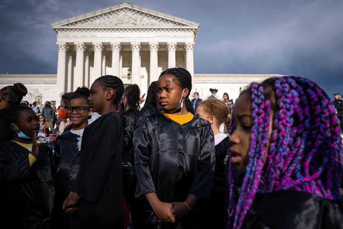 Maia Lewis, tengah, Nuri Brown-Lawrence, kanan, dan teman-teman mereka berkumpul di luar Mahkamah Agung di Washington pada 8 April 2022, untuk merayakan pengukuhan Ketanji Brown Jackson.