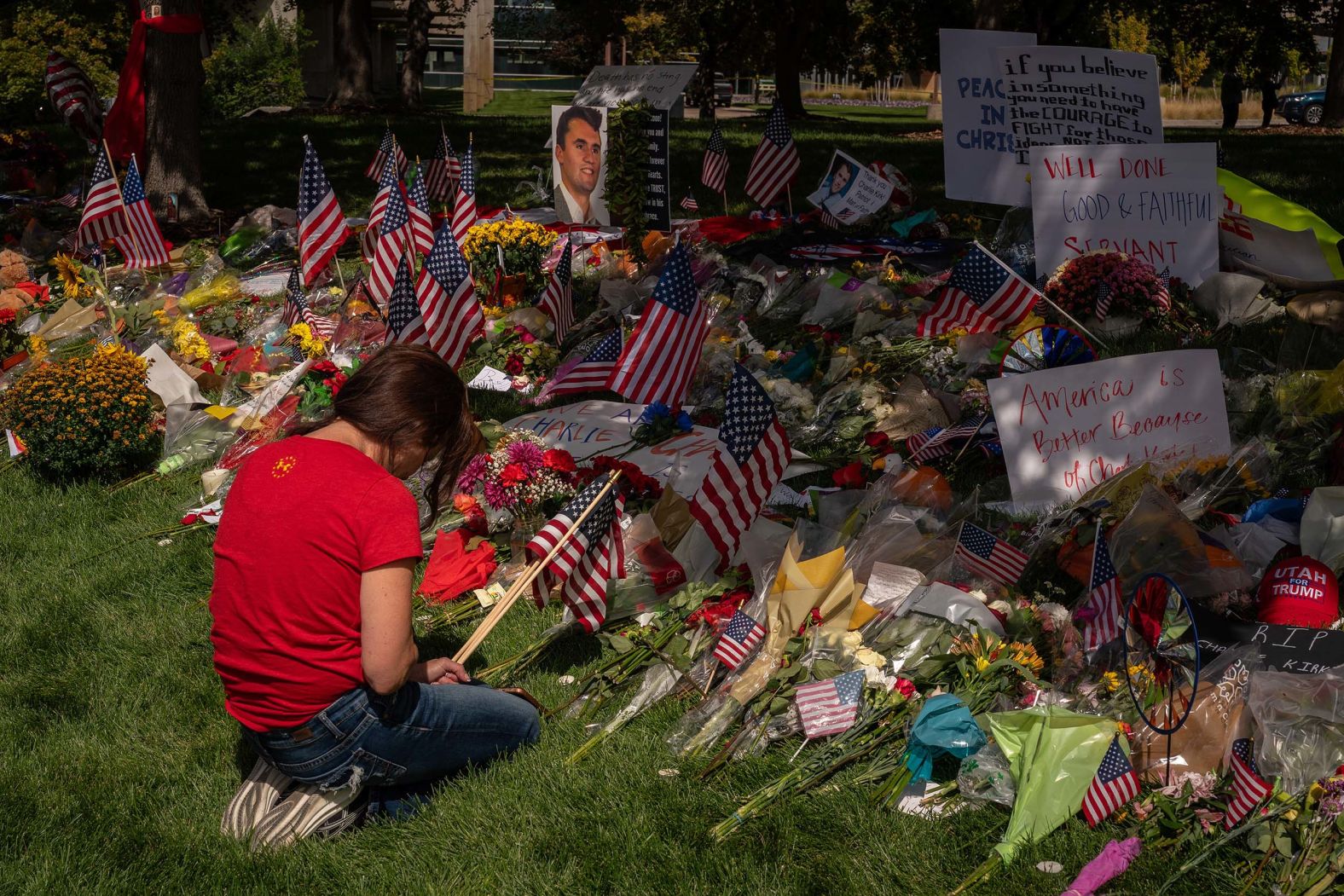 A person kneels while visiting a memorial for Charlie Kirk in Orem, Utah, on Sunday, September 14. Kirk, a conservative political activist and ally of US President Donald Trump, <a href="index.php?page=&url=https%3A%2F%2Fwww.cnn.com%2F2025%2F09%2F10%2Fpolitics%2Fcharlie-kirk-obituary">was fatally shot last week</a> while speaking at Utah Valley University.