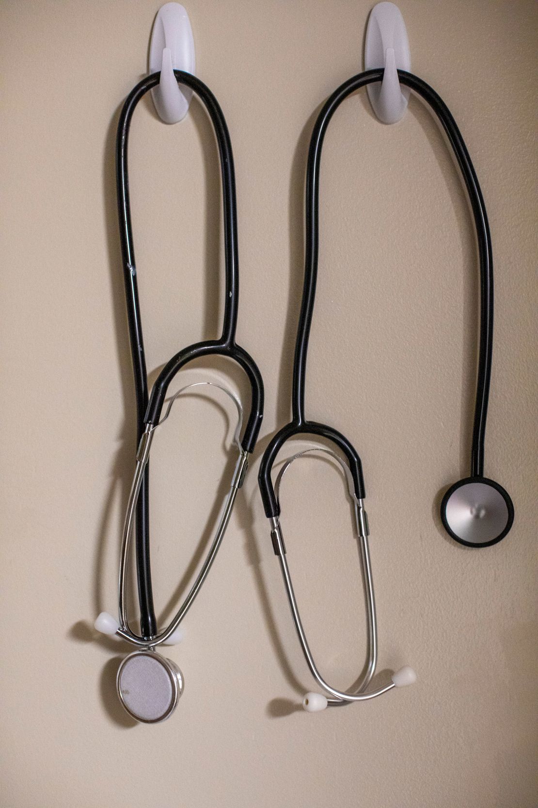 Stethoscopes hang on a wall inside a birthing room.