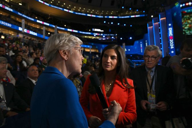 US Sen. Elizabeth Warren, left, talks to CNN's Kaitlan Collins on the convention floor on Wednesday.