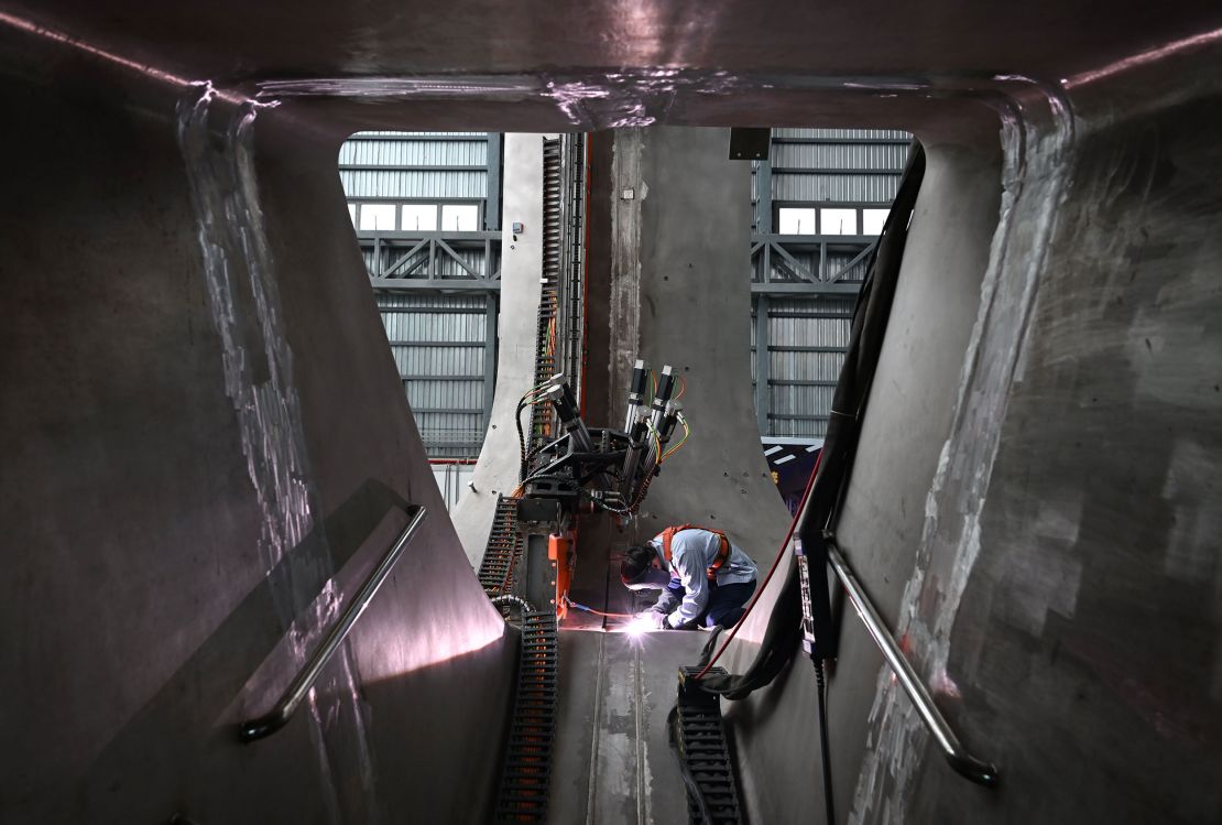 A staff member welds parts together at the CRAFT fusion research park in in Hefei, eastern China, in  September 2023. The BEST tokamak will be built next to CRAFT.