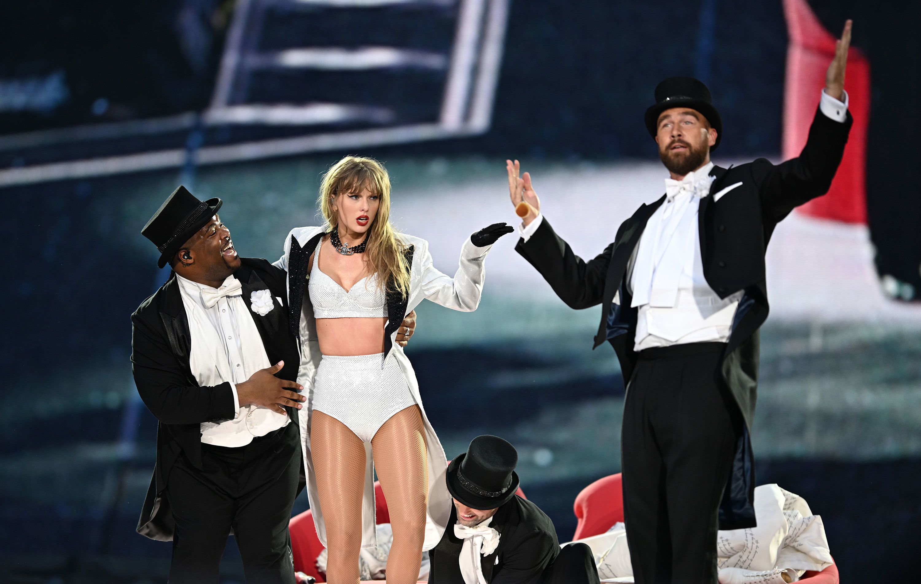 Football star Travis Kelce appears on stage with his girlfriend, Taylor Swift, during her concert at London’s Wembley Stadium on Sunday, June 23.