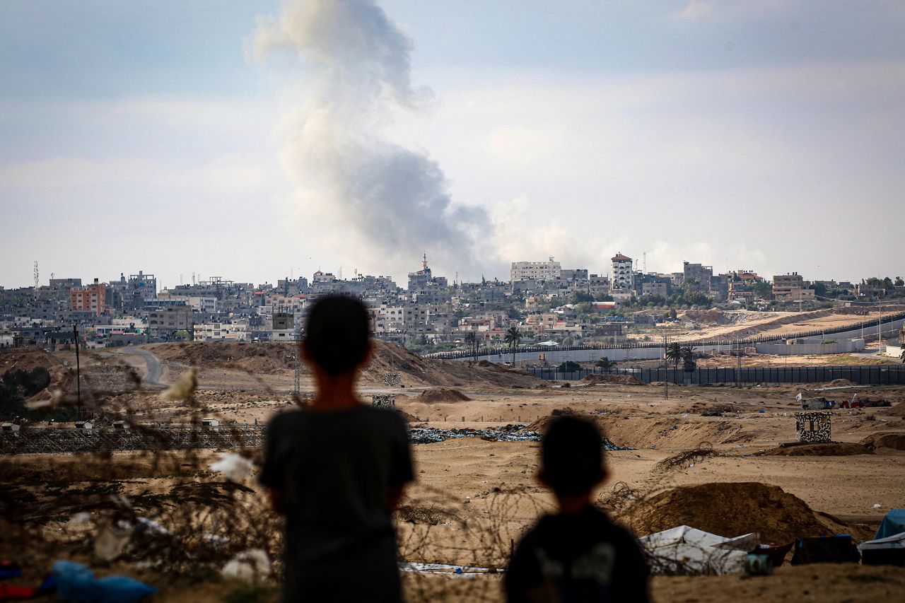 Boys watch smoke billowing during Israeli strikes east of Rafah in southern Gaza on May 13.