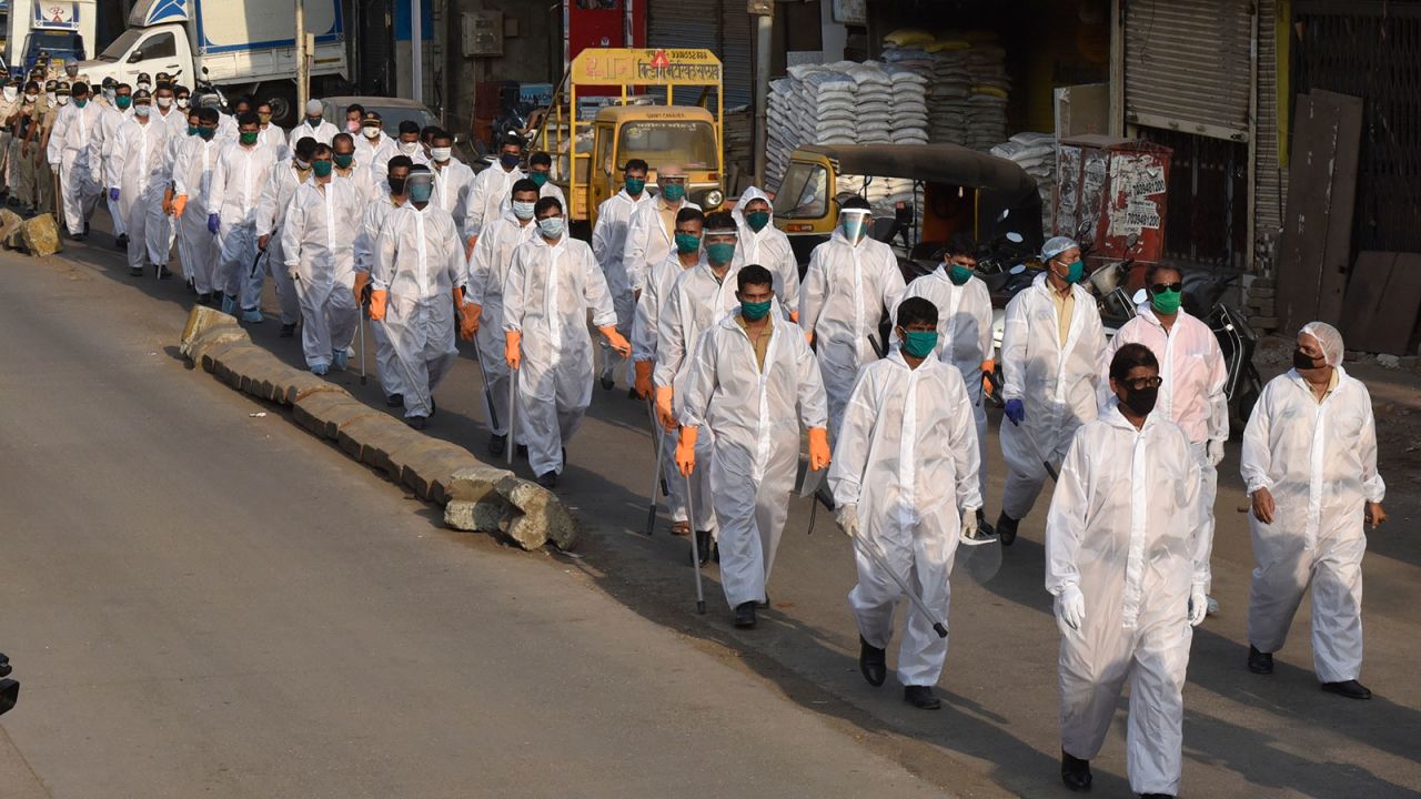 Police personnel march through Kandivali in Mumbai, India, during the nationwide lockdown on April 17.