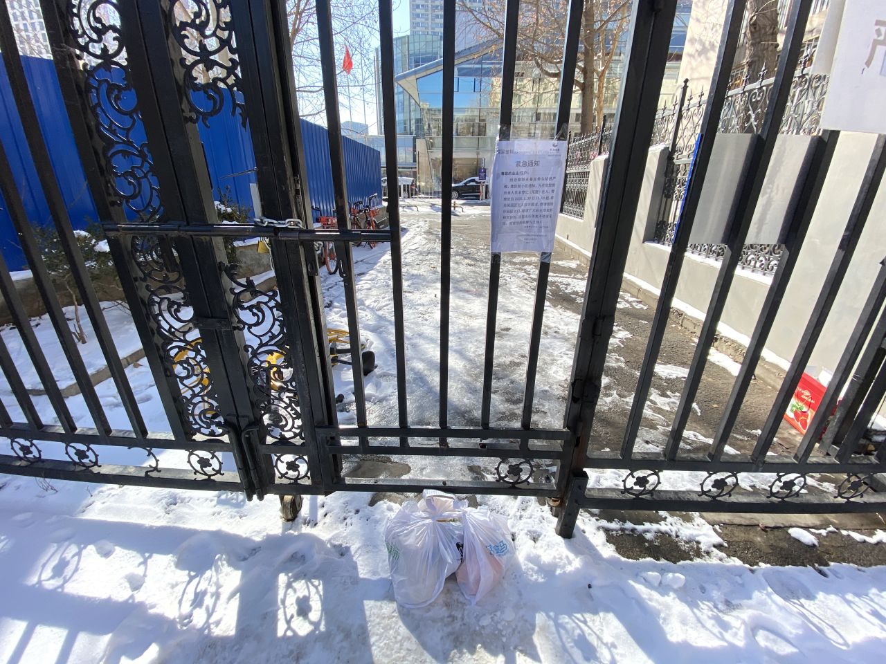 The side gate at the compound where deliveries are pushed through.