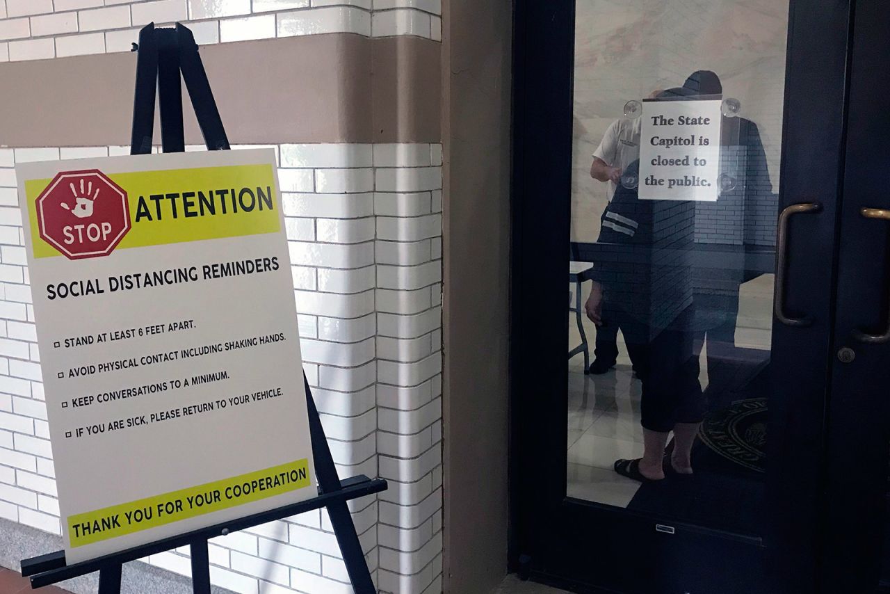 Signs outside the state Capitol in Little Rock, Arkansas, include reminders about social distancing.