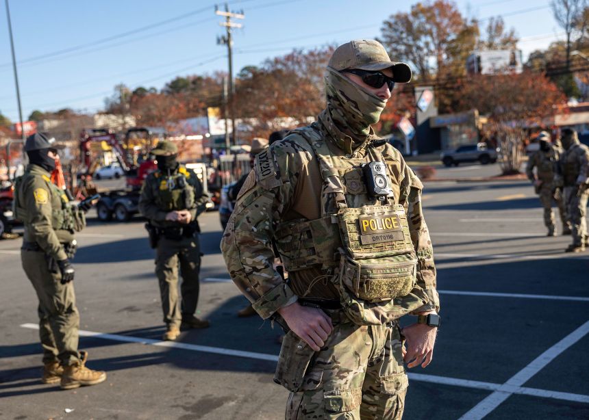 US Border Patrol agents stand outside a Home Depot store on November 19 in Charlotte, North Carolina.