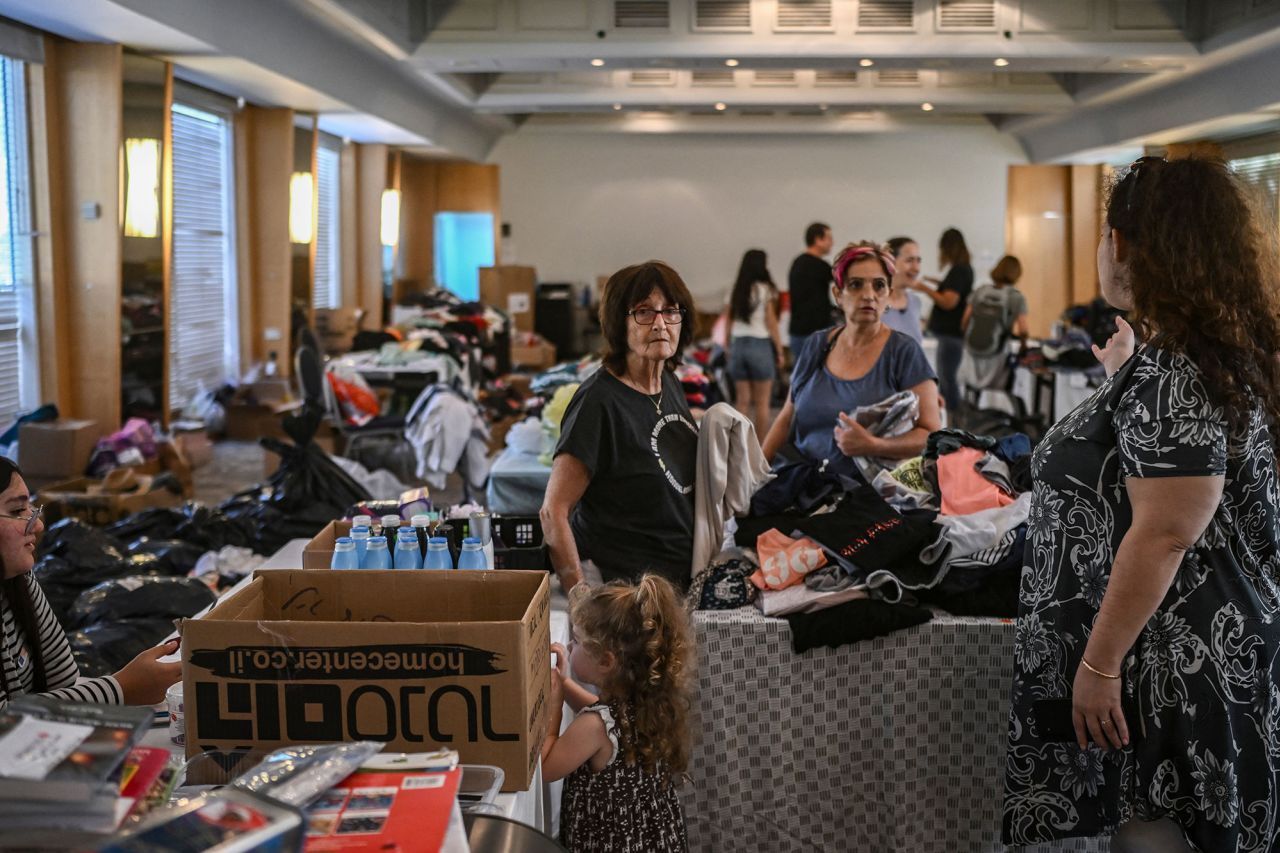 People receive clothes from donations at a hotel in the southern city of Eilat, Israel, on October 17, which is hosting survivors from the Israeli kibbutz of Nir Oz.