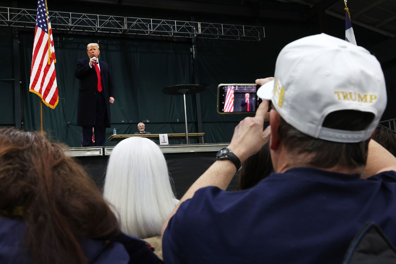 Former President Donald Trump speaks to voters during a visit to a caucus site at the Horizon Event Center on January 15, in Clive, Iowa.