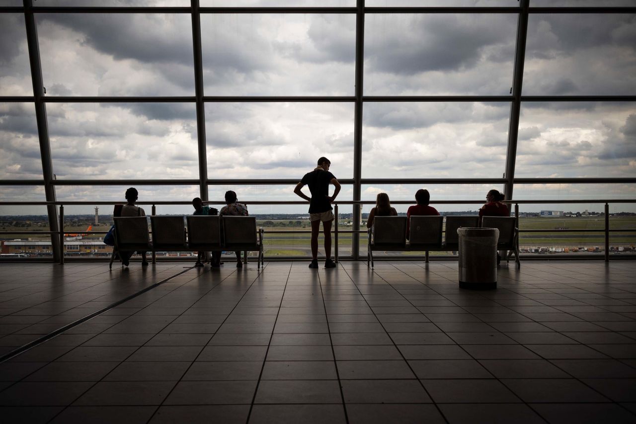 Passengers view planes from the observation deck at the OR Thambo International airport in Johannesburg, South Africa, on December 21, 2020.