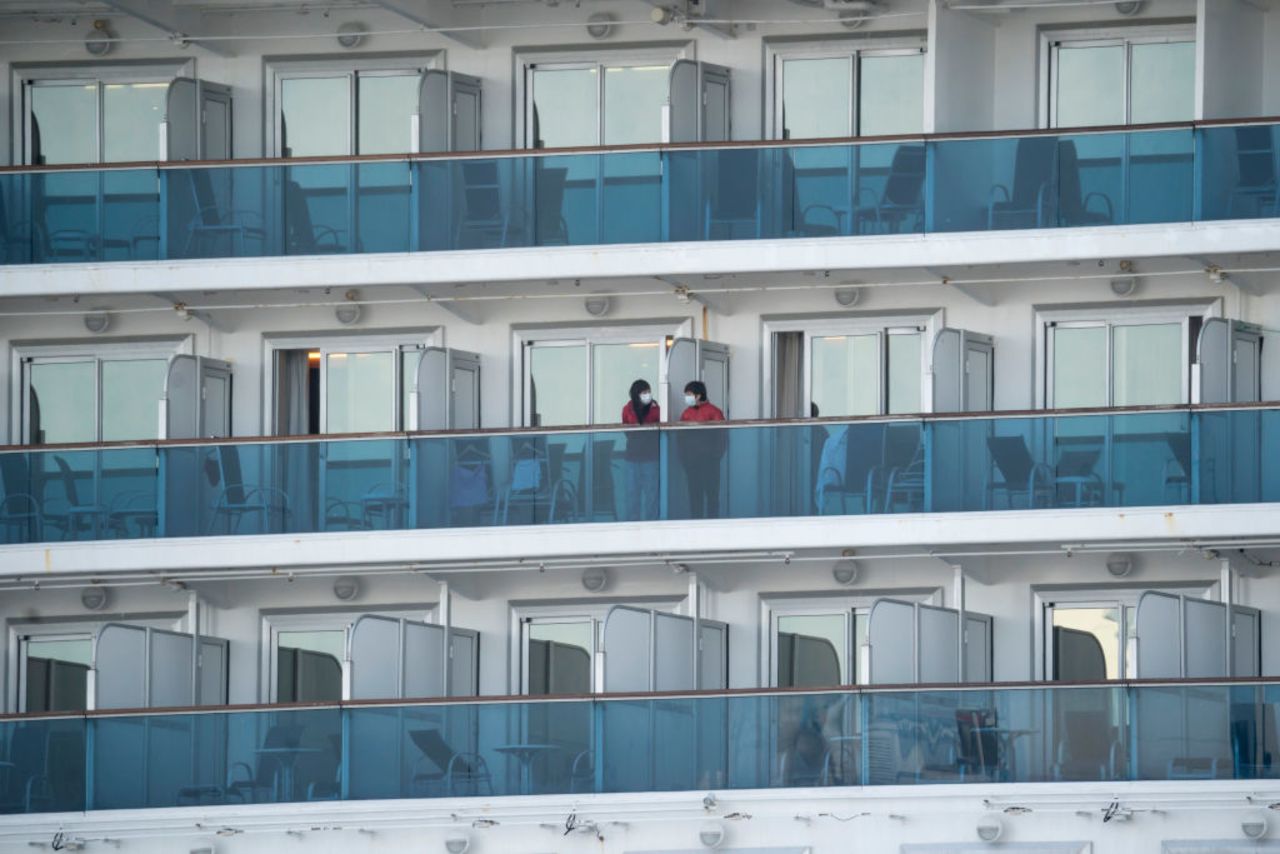 People are seen on the Diamond Princess cruise ship docked at Daikoku Pier on Wednesday, February 19, in Yokohama, Japan.