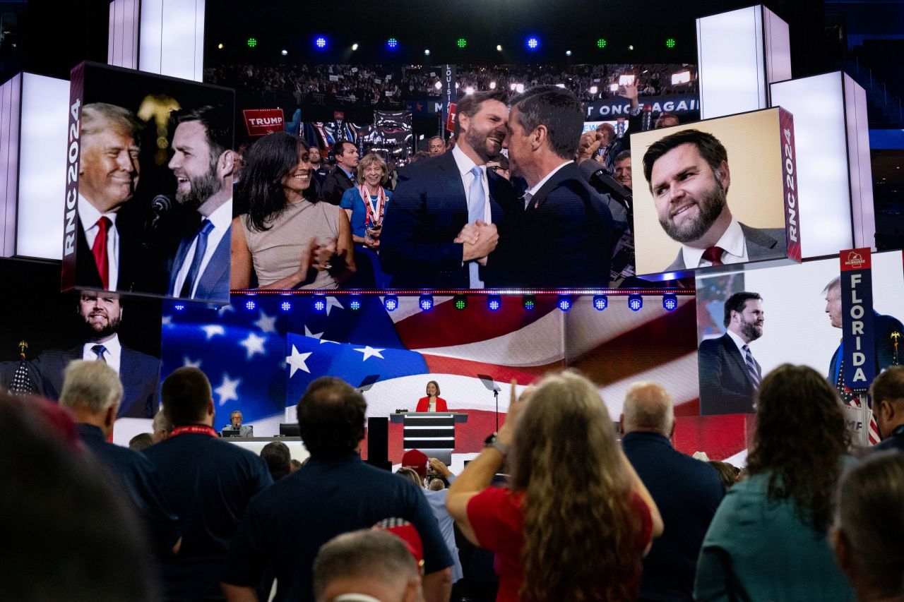 Iowa Attorney General Brenna Bird speaks at the Republican National Convention in Milwaukee's Fiserv Forum on Monday. On the screens above her is Ohio Sen. JD Vance, who was formally nominated as Donald Trump's running mate.