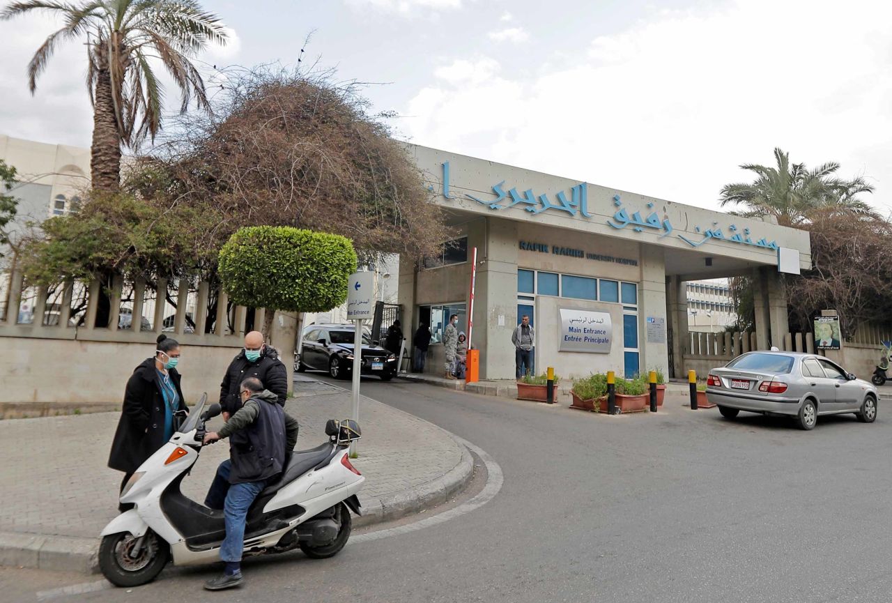 People wear protective masks outside the Rafik Hariri University Hospital in the outskirts of Beirut, Lebanon, where a coronavirus patient is being treated on February 21.