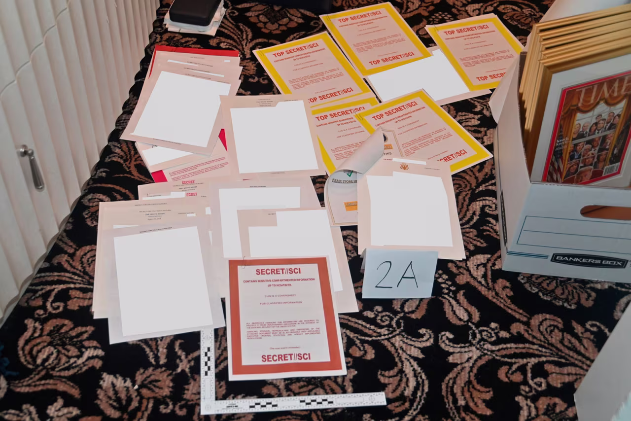 This image contained in a court filing by the Department of Justice on August 30 and partially redacted by the source, shows a photo of documents seized during the August 8 FBI search of former President Donald Trump's Mar-a-Lago estate. 