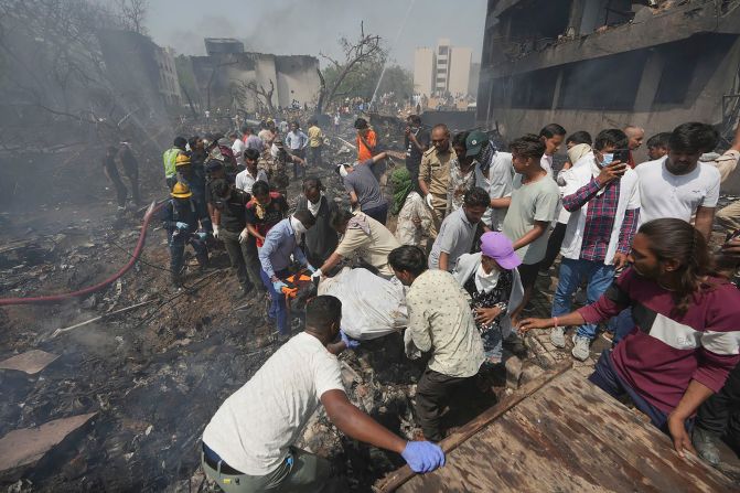 Rescuers carry a victim's body after <a  target="_top" href="/newspapers?url=https://www.cnn.com/2025/06/12/asia/plane-crash-india-ahmedabad">a passenger plane crashed into a residential area</a> shortly after taking off from the Indian city of Ahmedabad on Thursday, June 12.