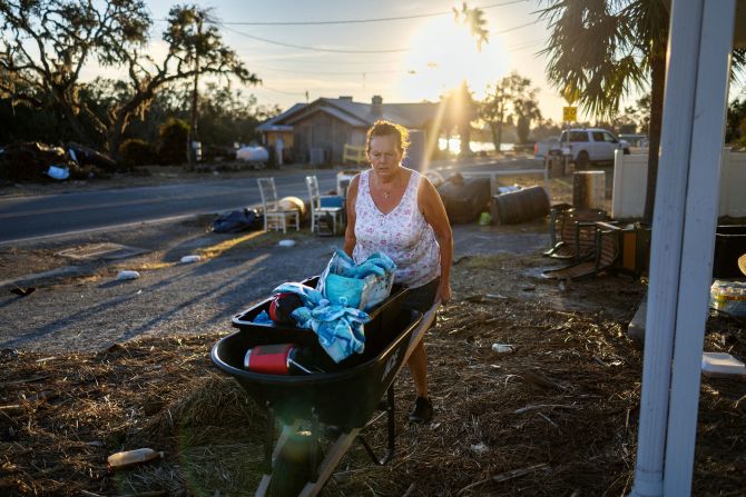 Melinda Segassie wheels possessions she salvaged from her home in Steinhatchee, Florida, on Sunday.