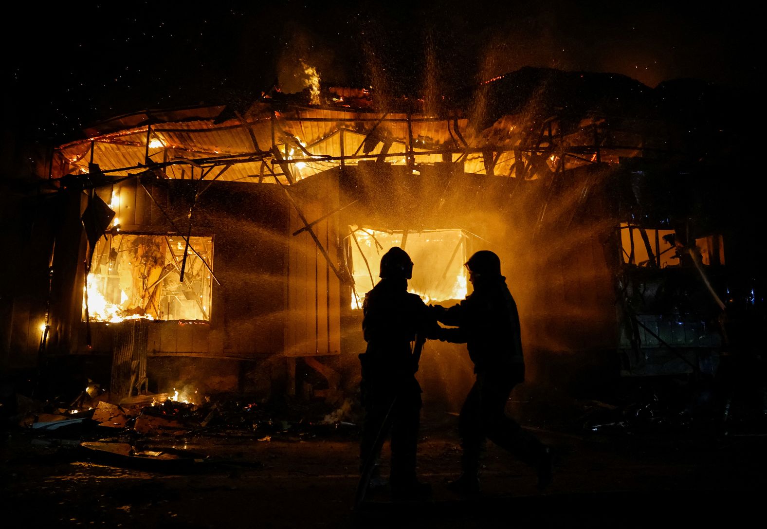 Firefighters work to extinguish a fire after shelling in the Russian-controlled Donetsk region of Ukraine on Monday, June 30.