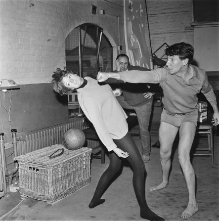 Actor Robert Stephens throws a stage punch at  Smith during a rehearsal in 1966. Stephens and Smith married the following year and had two children together.