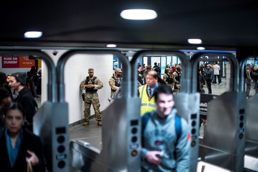 Members of the New York State National Guard monitor a checkpoint inside the entrance of a New York subway station on March 7, 2024, after they were deployed by New York Gov. Kathy Hochul.