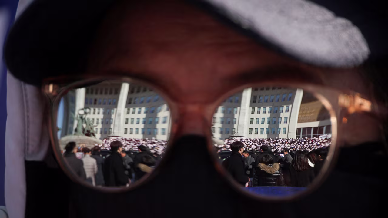 A protester attends a rally to condemn Yoon.