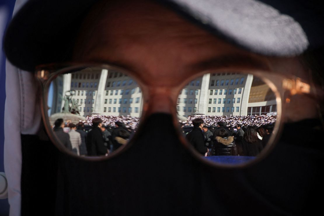 People and lawmakers attend a rally to condemn South Korean President’s surprise declarations of the martial law, at the national assembly in Seoul, South Korea, December 4, 2024.