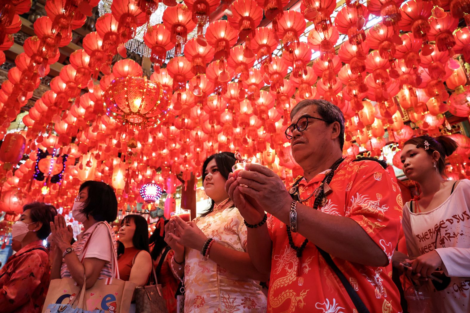 A man prays to gods as part of the traditional worship rituals on the eve of the Lunar New Year at a temple in Chinatown, Bangkok, Thailand, on Tuesday, January 28.
