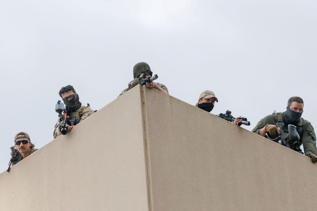 Snipers perch on the roof of a US Immigration and Customs Enforcement building in Portland, Oregon, during a protest on October 4.