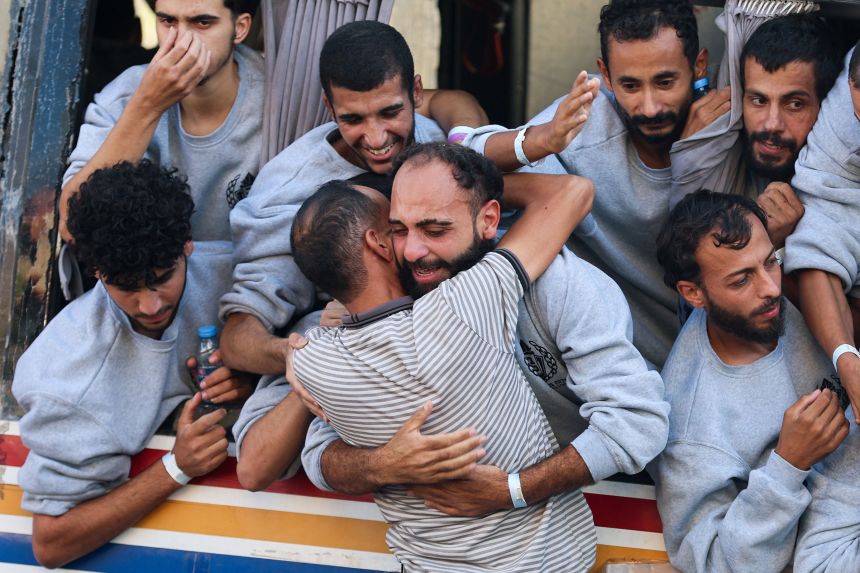 A Palestinian prisoner released by Israel as part of a hostages-prisoners swap and a ceasefire deal between Hamas and Israel, hugs a man in Khan Younis on October 13, 2025.