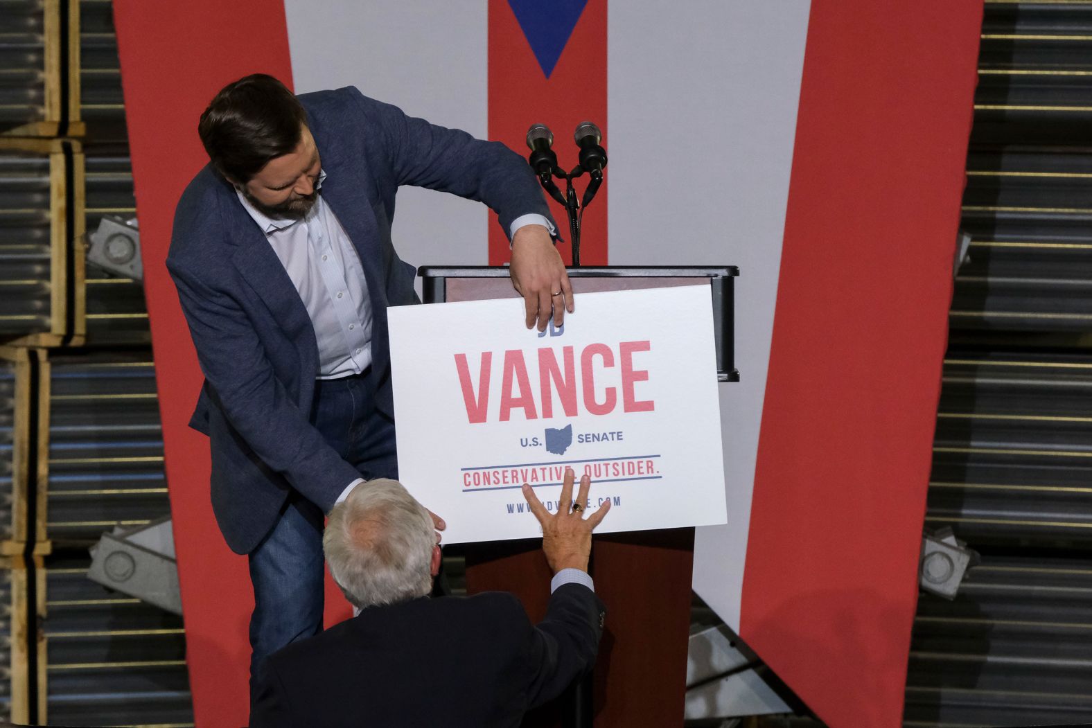 Vance adjusts a fallen sign during a campaign rally in Middletown, Ohio, in July 2021. There, he announced that he would be running for the US Senate seat being left by retiring Sen. Rob Portman.