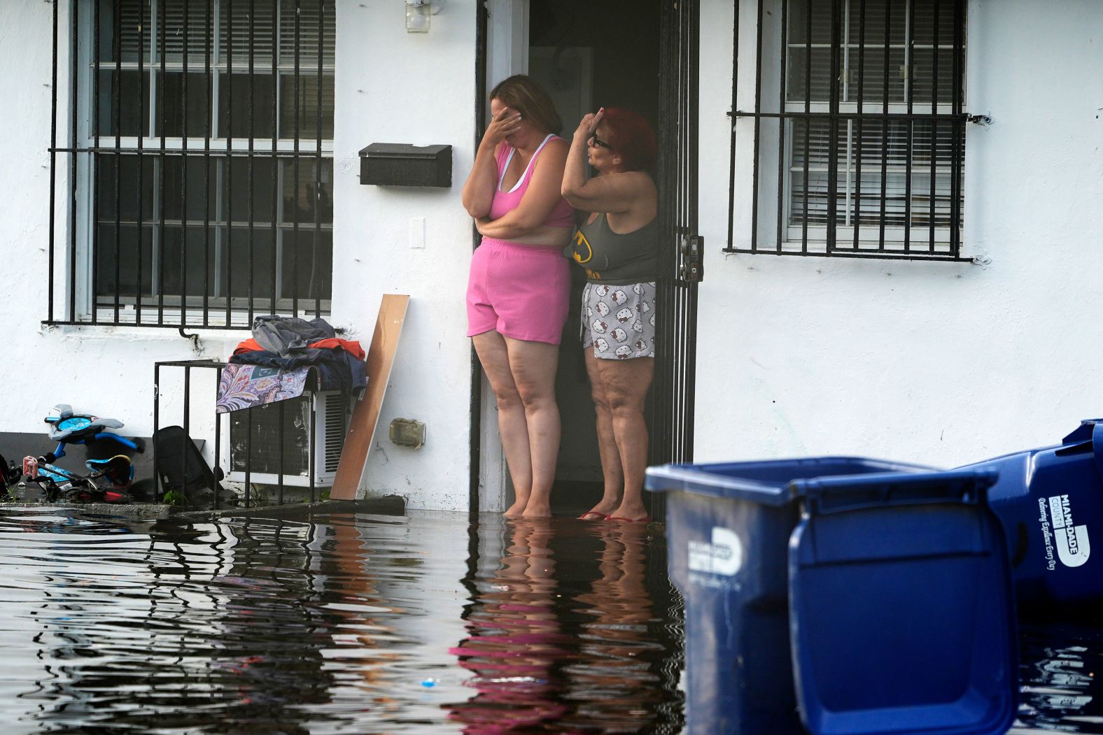 Two women react as they see flooding on their street in North Miami, Florida, on Thursday, June 13. <a href="https://www.cnn.com/2024/06/13/weather/florida-flooding-storm-forecast-thursday/index.html">Heavy rainfall has deluged South Florida</a> since Tuesday morning, prompting Florida Gov. Ron DeSantis to declare a state of emergency for Broward, Collier, Lee, Miami-Dade and Sarasota counties.