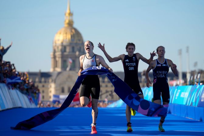 Triathlete Laura Lindemann, left, celebrates after she crossed the finish line <a href="https://www.cnn.com/sport/live-news/paris-olympics-news-2024-08-05#h_1daac4b41669abd11d80548ac2296483">to give Germany gold in the mixed relay</a> on August 5.